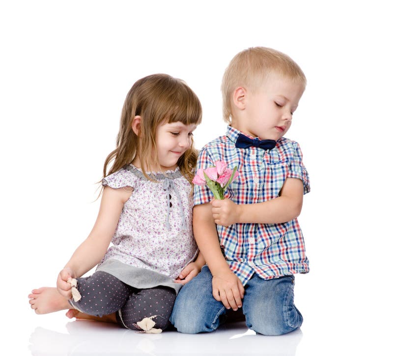 Shy boy gives to the girl a flower. on white background