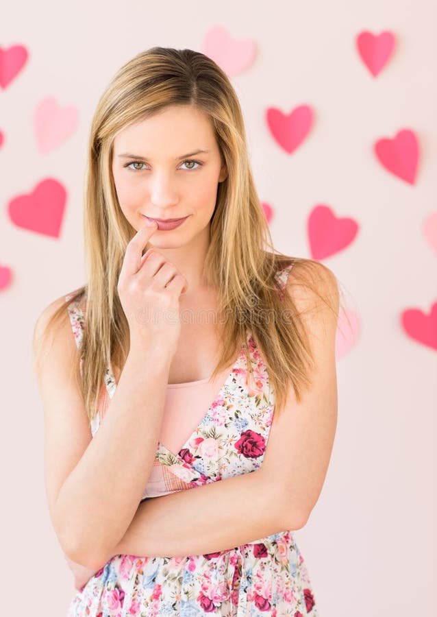 Shy Woman With Heart Shaped Papers Against Colored Background