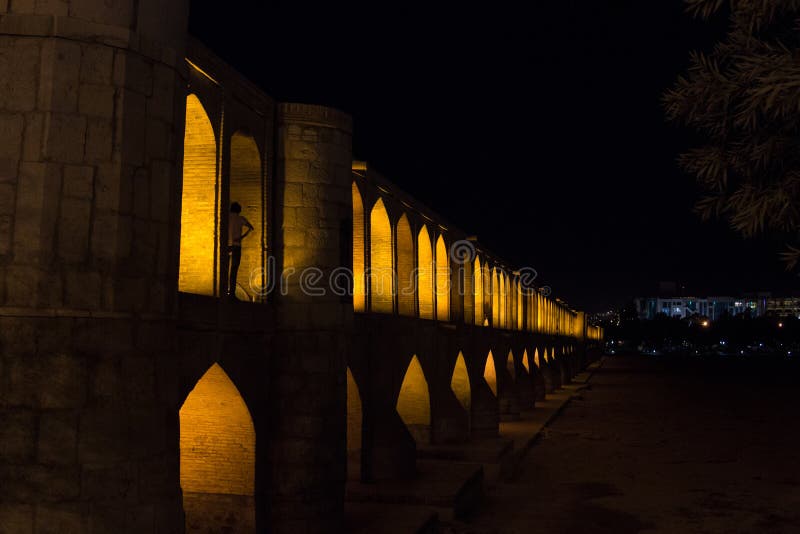 Si o Seh Pol bridge on a dark evening in Isfahan, Iran. Also known as Allahverdi Khan Bridge, or 33 arches bridge, it is a major landmark of the city and a symbol of the Persian Safavid Architecture Picture of the iconic bridge of Si o Seh, in the center of Isfahan. The river Zayandeh is dry due to the season. The Allahverdi Khan Bridge, it is the largest of the eleven historical bridges on the Z. Si o Seh Pol bridge on a dark evening in Isfahan, Iran. Also known as Allahverdi Khan Bridge, or 33 arches bridge, it is a major landmark of the city and a symbol of the Persian Safavid Architecture Picture of the iconic bridge of Si o Seh, in the center of Isfahan. The river Zayandeh is dry due to the season. The Allahverdi Khan Bridge, it is the largest of the eleven historical bridges on the Z