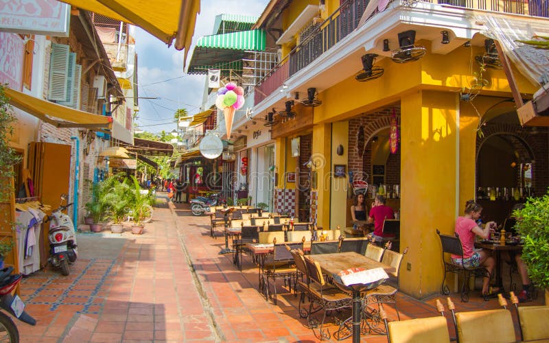 SIAM REAP, CAMBODIA – FEBRYARY 20, 2015: A tourist street with small cafes and shops in the old French quarter royalty free stock photo SIAM REAP, CAMBODIA – FEBRYARY 20, 2015: A tourist street with small cafes and shops in the old French quarter royalty free stock photo