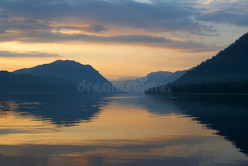 Siberia. Mirror of Teletskoye lake in the morning