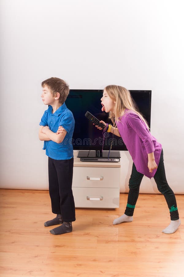 Siblings Conflict Over The Remote Control Stock Image Image Of Struggling Sitting 79177311