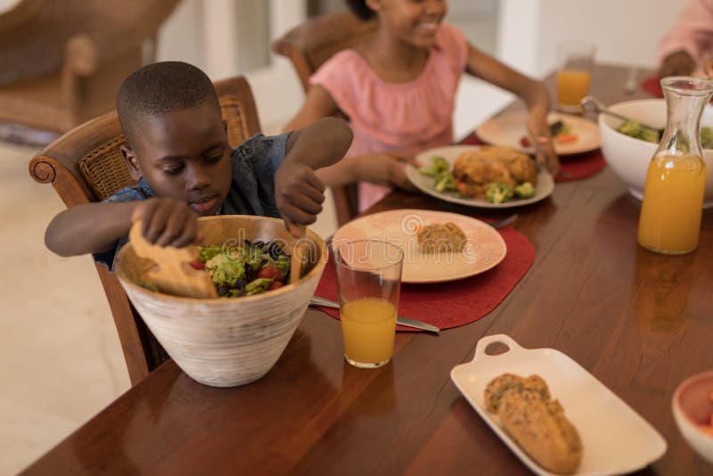 Siblings having meal together on dining table royalty free stock images Siblings having meal together on dining table royalty free stock images