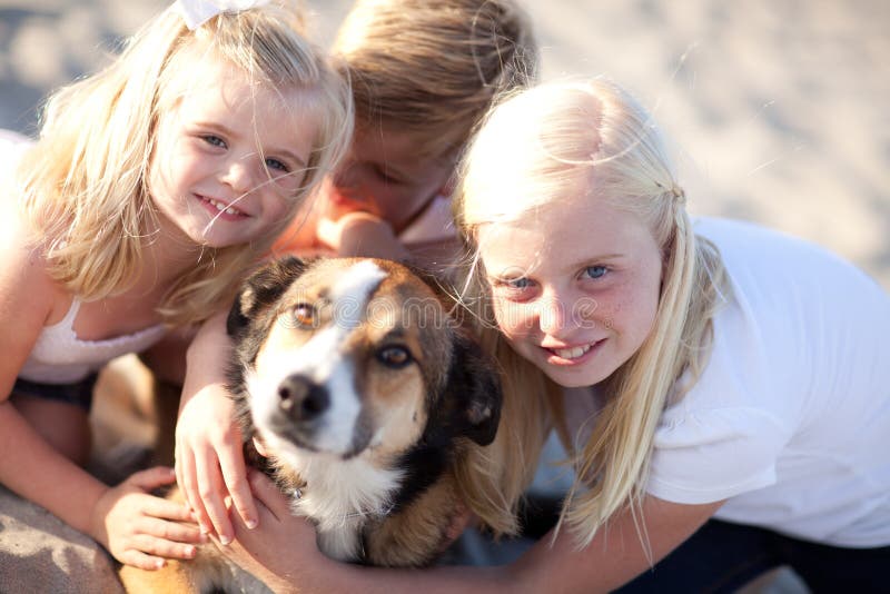 Siblings Playing with Their Pet Dog