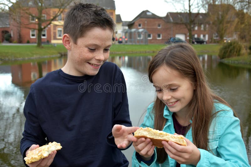 Siblings sharing pastry