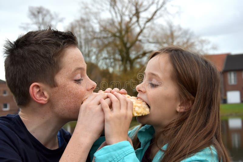 Siblings sharing pastry stock image Siblings sharing pastry stock image
