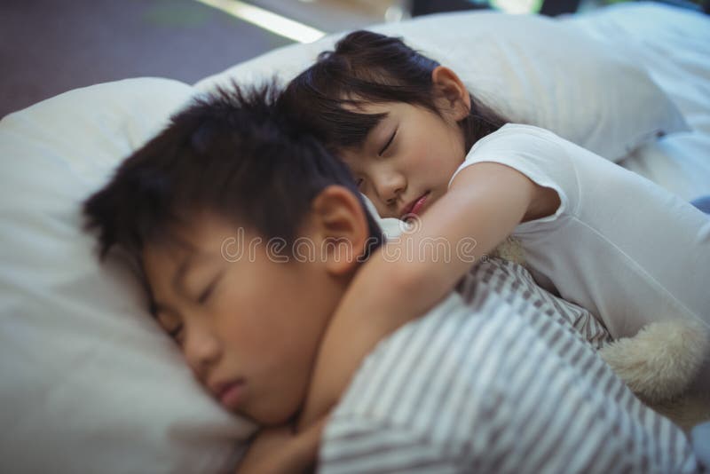 Siblings Sleeping Together in Bed in Bedroom Stock Photo Image of