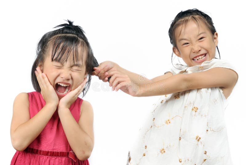 Siblings teasing, asian little girl pulling her sister s hair