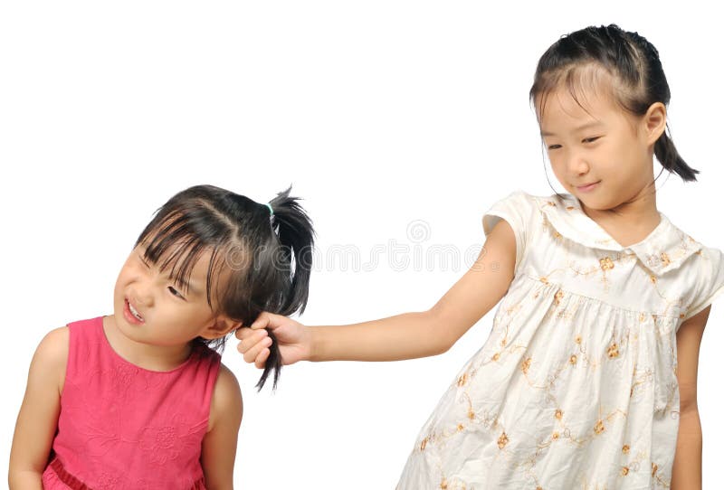 Siblings teasing, asian little girl pulling her sister s hair