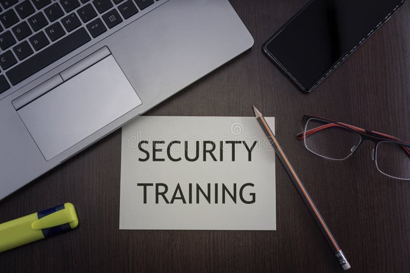 Security training concept. Top view of laptop, phone, glasses and pencil with card with inscription security training. Security training concept. Top view of laptop, phone, glasses and pencil with card with inscription security training.