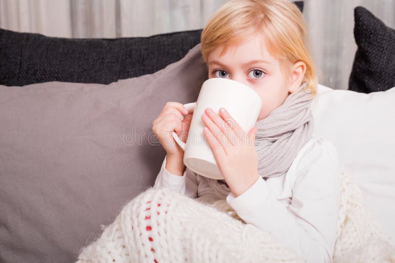 Sick child drinking tea