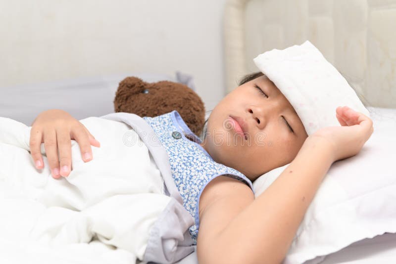 Sick child with high fever laying in bed royalty free stock images Sick child with high fever laying in bed royalty free stock images