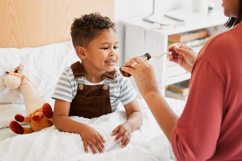 Sick child taking medicine, syrup and treatment for recovery of cold illness, flu sickness and virus symptoms. Mom