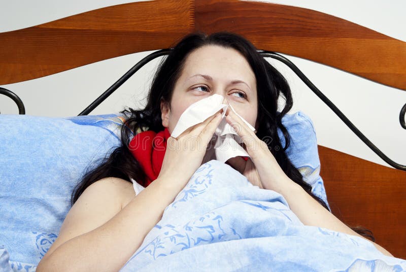 Sick girl blowing his nose