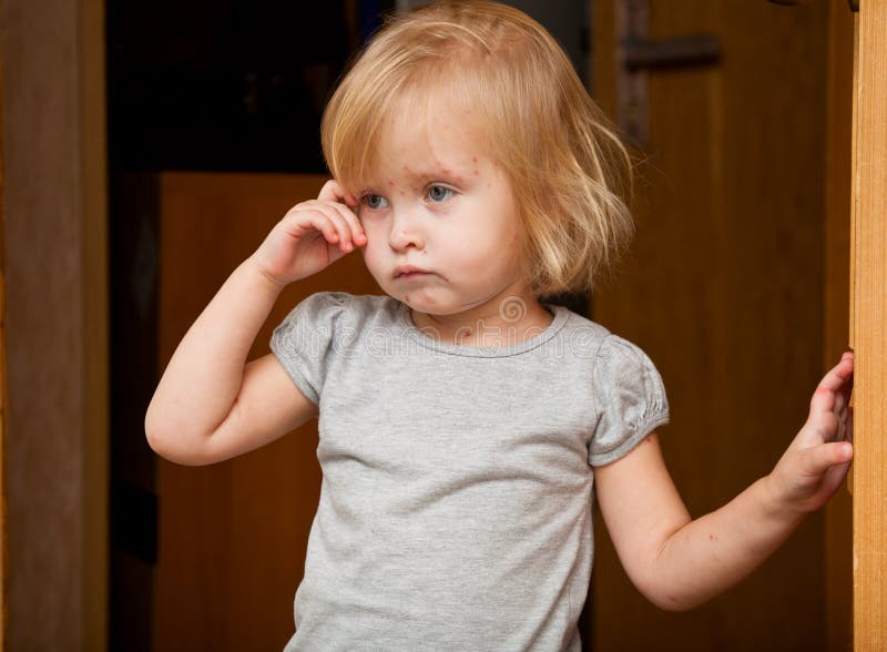 A sick girl is near the door stock image A sick girl is near the door stock image