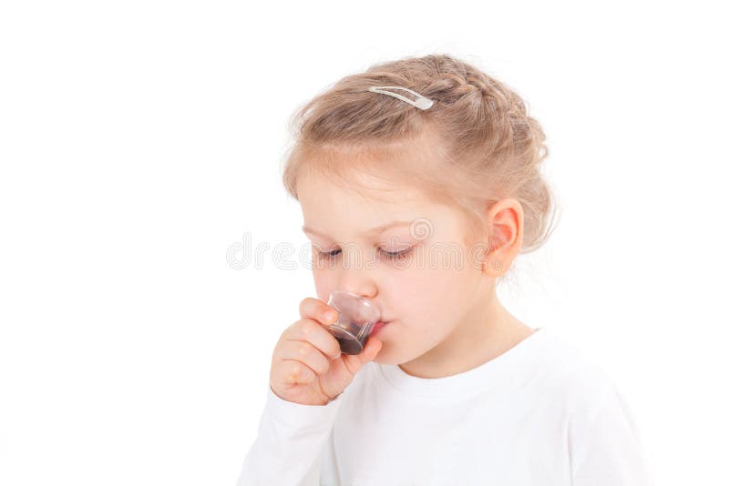 Sick girl taking cough syrup royalty free stock photography