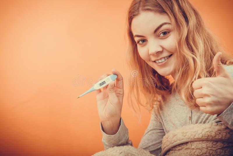 Sick ill woman with digital thermometer.