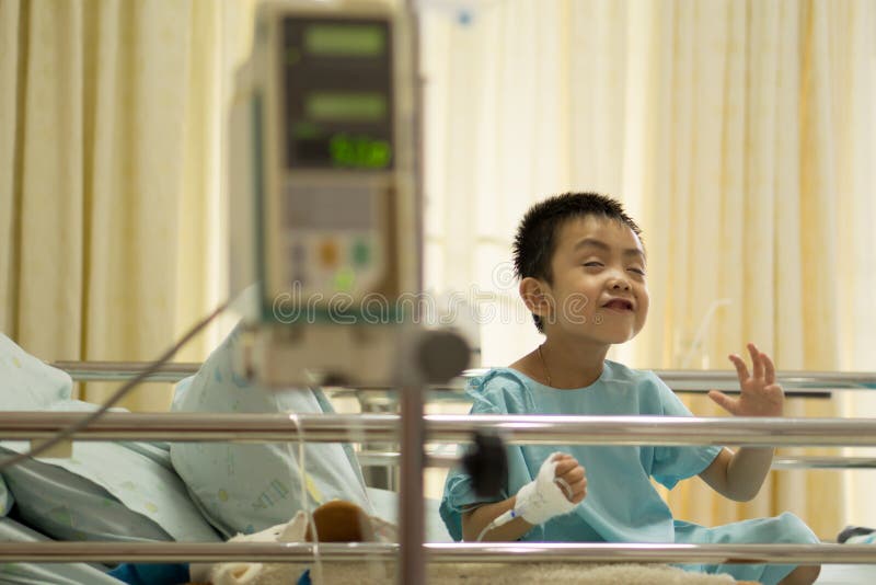 A Sick Little Boy in Hospital Bed. Stock Photo Image of laugh, asian