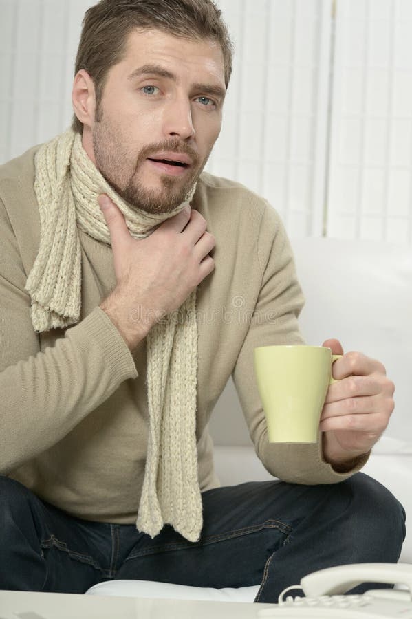 Sick man drinking warm tea stock photo. Image of cold 78310250