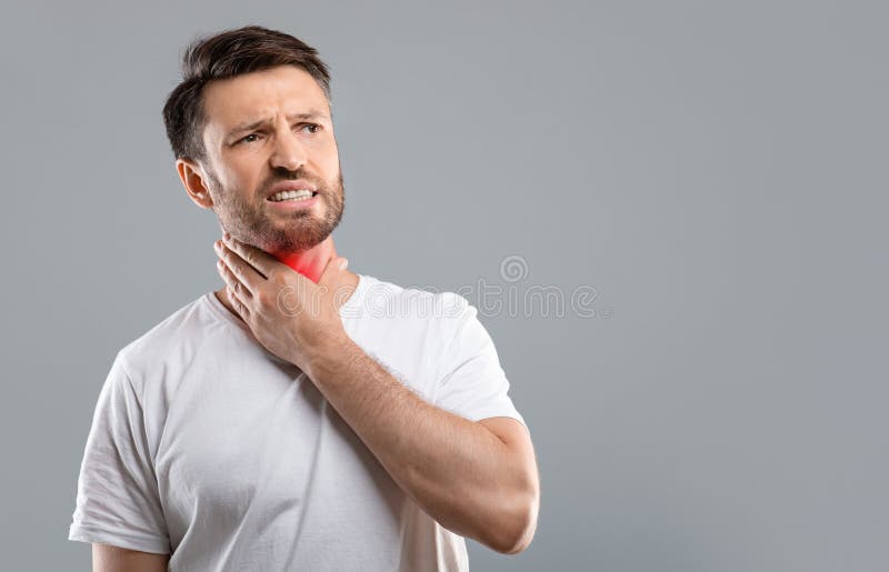 Sick man having sore throat, looking at copy space stock photography