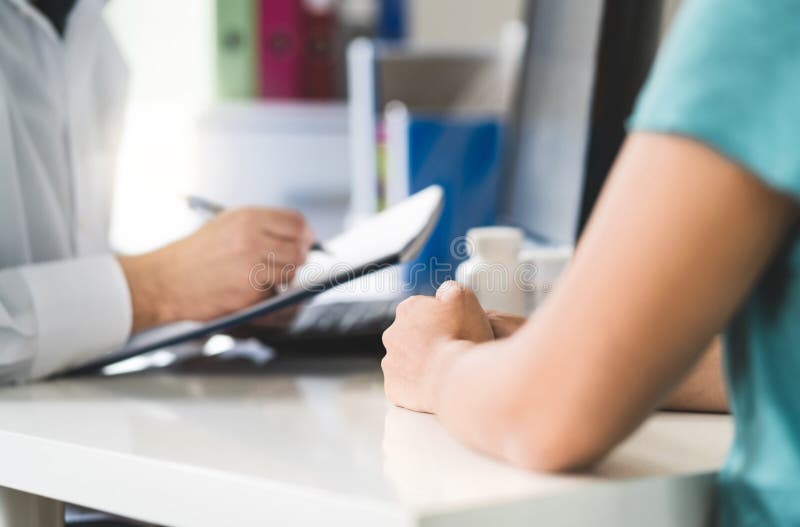 Sick patient visiting doctor in health care center or emergency room. stock photo