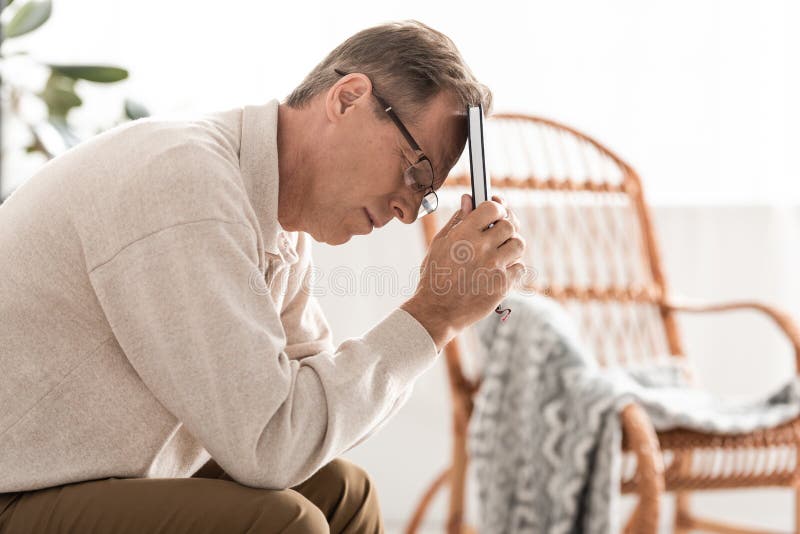 Sick Retired Man in Glasses Holding Notebook. Stock Photo Image of