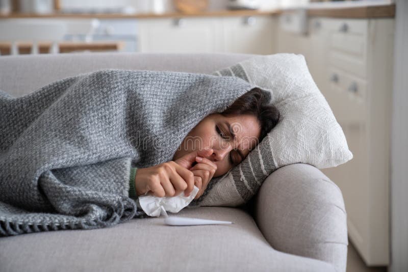 Sick Unhealthy Woman Lying Under Blanket on Sofa Coughing and Sneezing
