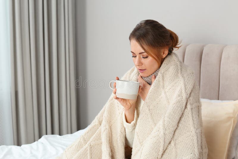 Sick Woman with Warm Plaid and Cup of Drink in Bed at Home Stock Image ...