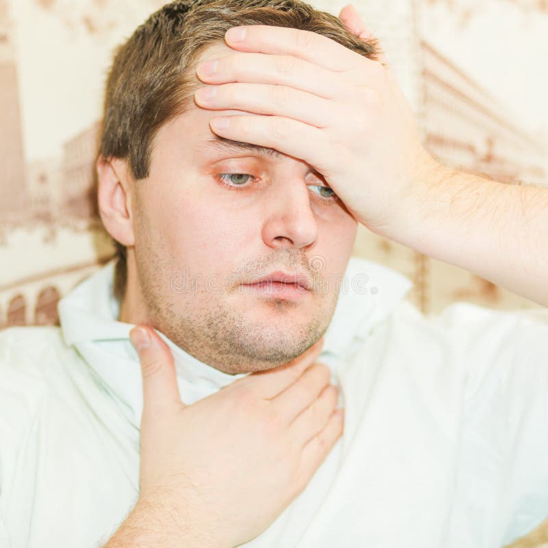 A Cold Young Man Sneezes into Stock Photo Image of holds, assistance