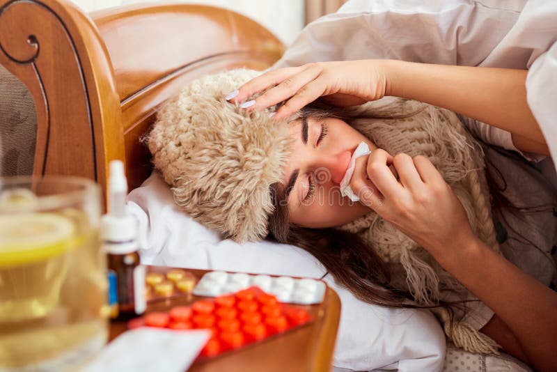 Sick young woman on the bed in the room stock images Sick young woman on the bed in the room stock images