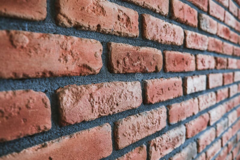 Side Angle of a Red Brick Wall. Close Up View of Cracked Weathered