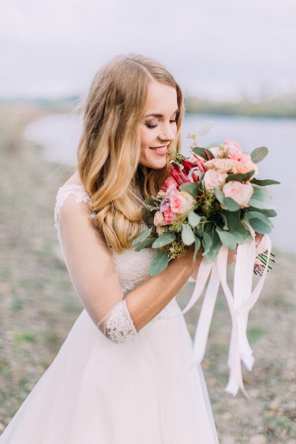 Side Portrait of the Bride Smelling the Wedding Bouquet. the Beach ...