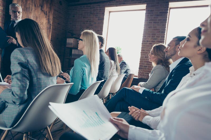 Side profile close up view photo of serious attentive smart large crowd listening to chief ceo boss employer financier stock photo Side profile close up view photo of serious attentive smart large crowd listening to chief ceo boss employer financier stock photo