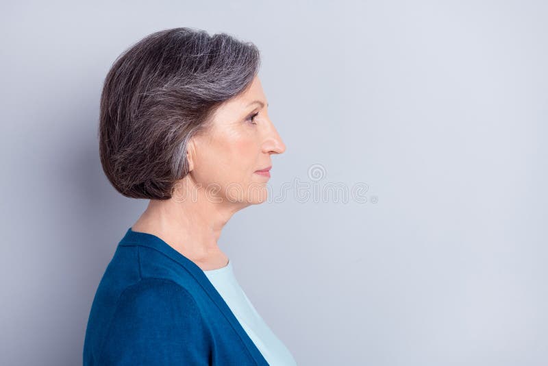 Side profile photo portrait of serious elder woman looking empty space isolated on grey color background