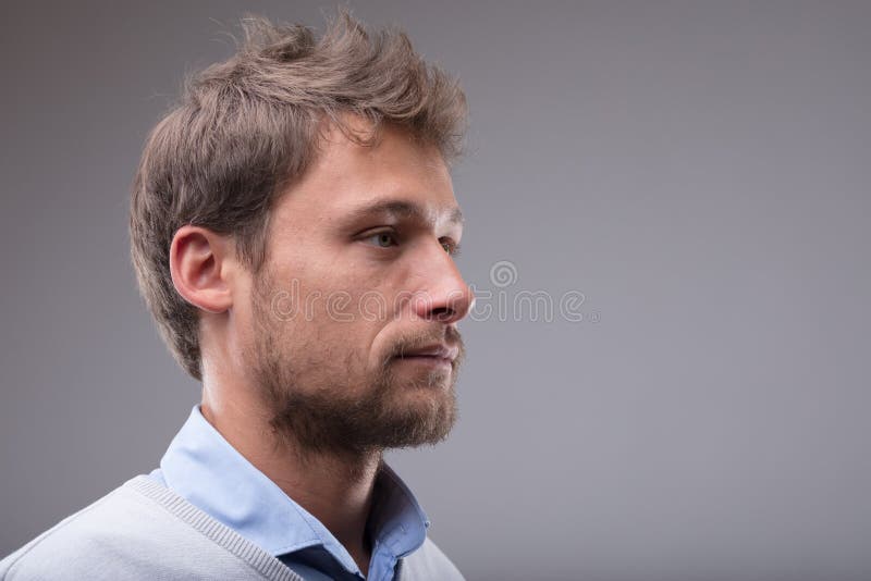 Side profile portrait of a young blond man royalty free stock image