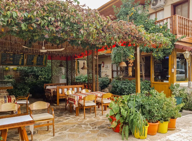 Side, Turkey, November 2019: Rustic Outdoor Cafe, with Wooden Tables and  Chairs, Wrapped in Wild Grapes and Next To the Sea. No Editorial Photo -  Image of outdoor, restaurant: 195738956