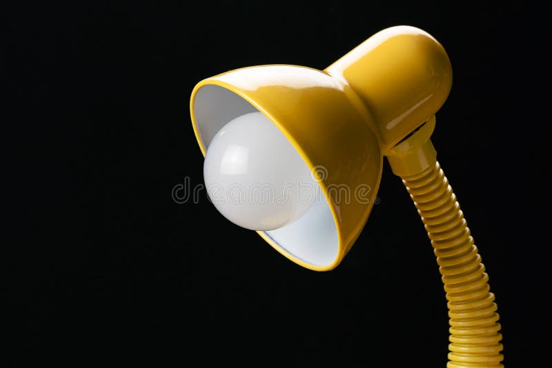 Side View of Adjustable Yellow Desk Lamp Isolated on Black Background