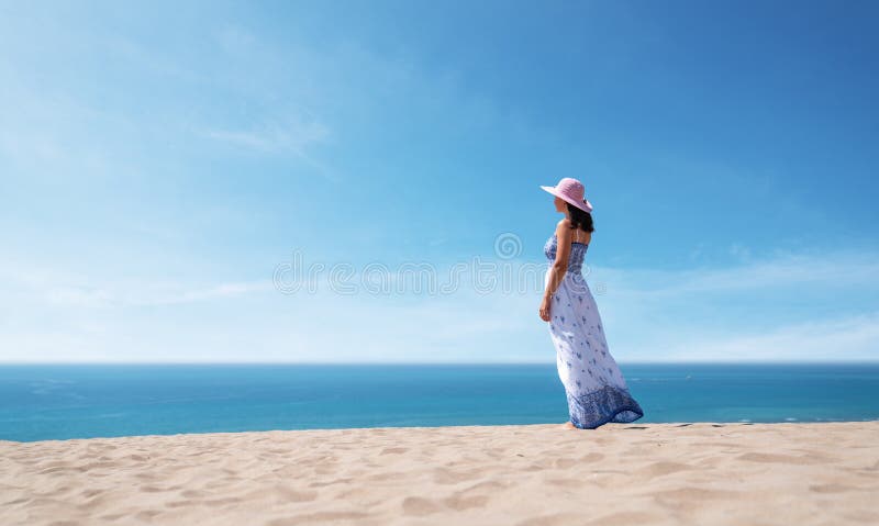 Side view of beautiful woman in a dress enjoying the idyllic scene of the sun, sand and sea. Beautyful sandy Patara royalty free stock image Side view of beautiful woman in a dress enjoying the idyllic scene of the sun, sand and sea. Beautyful sandy Patara royalty free stock image