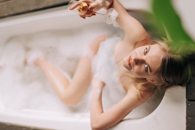 Cute blond playing with herself in the bath