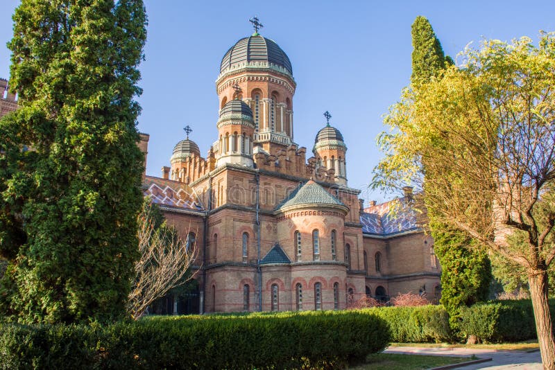 Side view of building of Church of Three Saints in greenery in tettitory of Chernivtsi National Public University