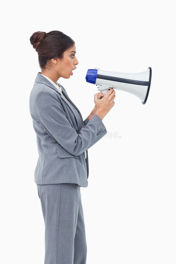 Side view of businesswoman using megaphone against a white background
