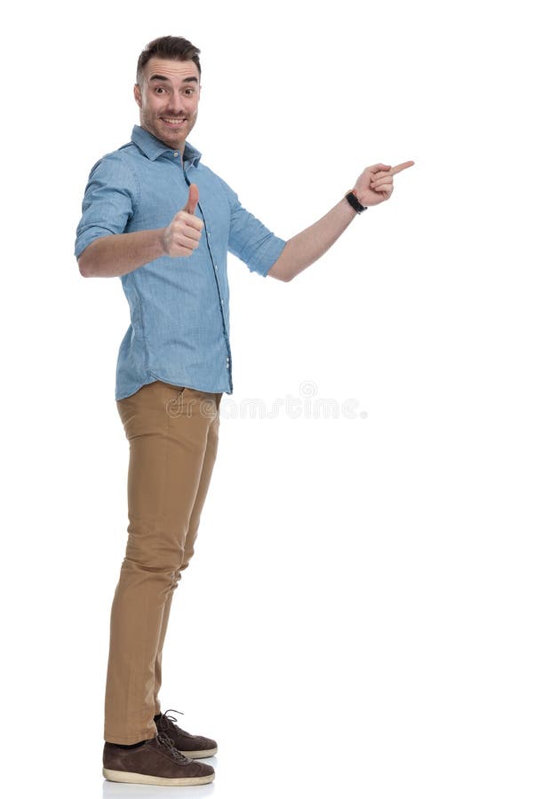 Side view of cheerful casual man pointing and gesturing ok