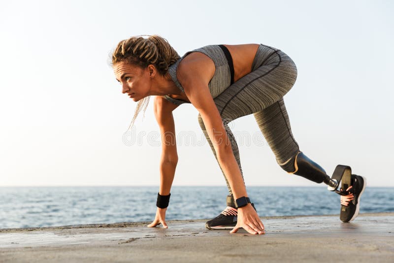 Side view of disabled athlete woman with prosthetic leg