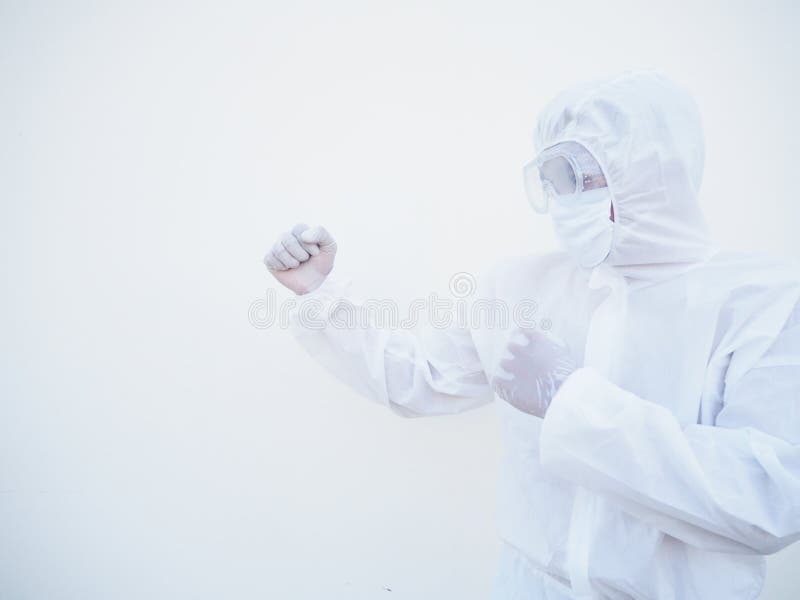 Side view doctor or scientist in PPE suite uniform standing with raised fists like boxer for fight with coronavirus or COVID-19 stock image