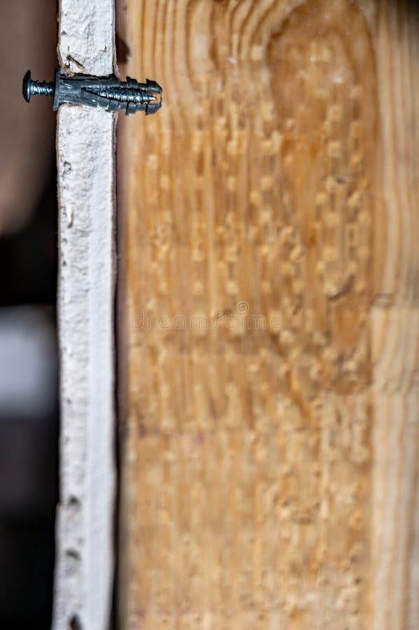 Side View of a Drywall Mount Anchor and Stock Photo Image of drilling
