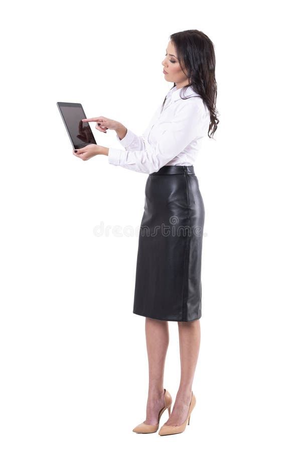 Side view of elegant young business woman using interactive tablet touch screen. stock images