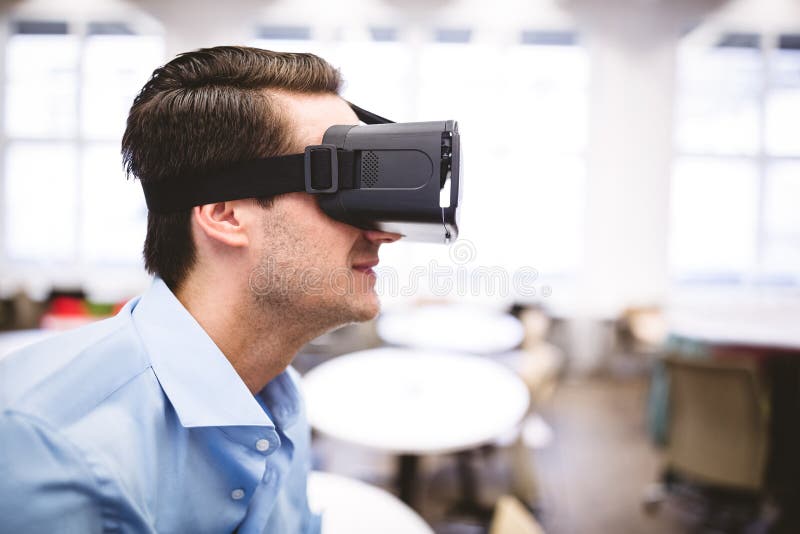 Side View of Executive Enjoying Virtual Reality Headset at Office Stock