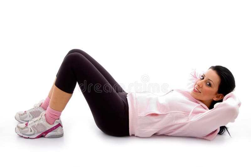 Side view of exercising female on white background