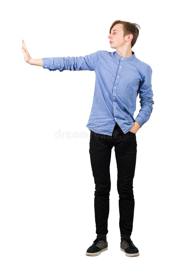 Side view full length of confident boy showing stop gesture with his palm, hand outstretched gesturing prohibition, no sign, royalty free stock photography Side view full length of confident boy showing stop gesture with his palm, hand outstretched gesturing prohibition, no sign, royalty free stock photography