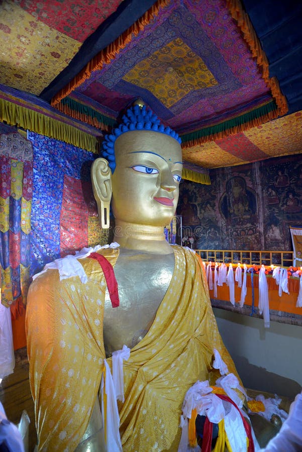 Side view of the gilded gold statue of Shakyamuni Buddha in Shey Gompa, a Tibetan monastery located near Leh in Ladakh, India.